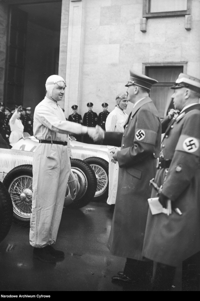Adolf Hitler greets motorcyclists in white suits during the International Motor Show in Berlin